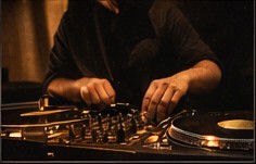Hands preparing a vinyl only DJ set